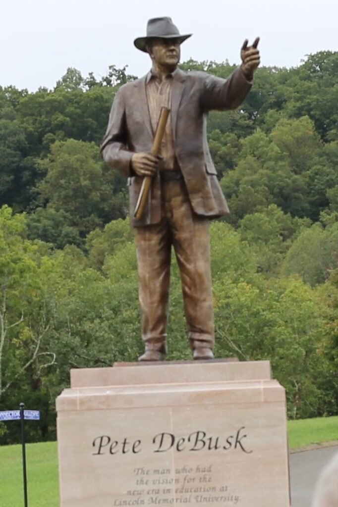 bronze sculpture of a man in a hat
