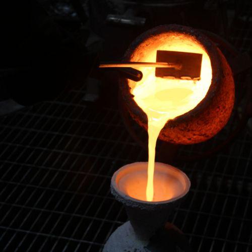Closeup of melted bronze being poured